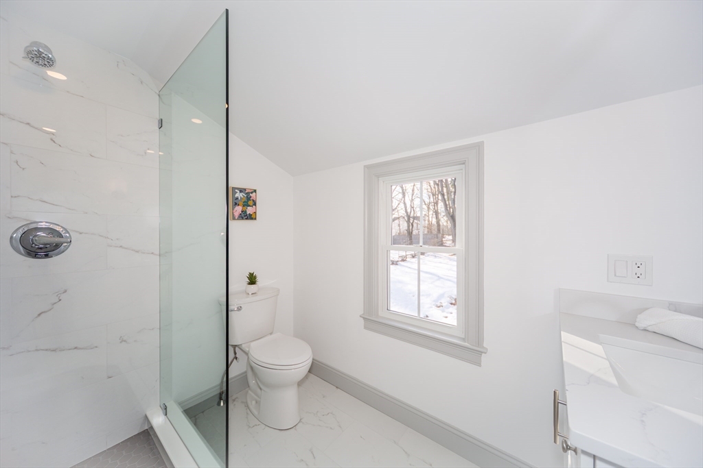 12 Bay State Road Natick, MA 01760 - Photo 22 of 35 a bathroom with a toilet sink a shower and a window