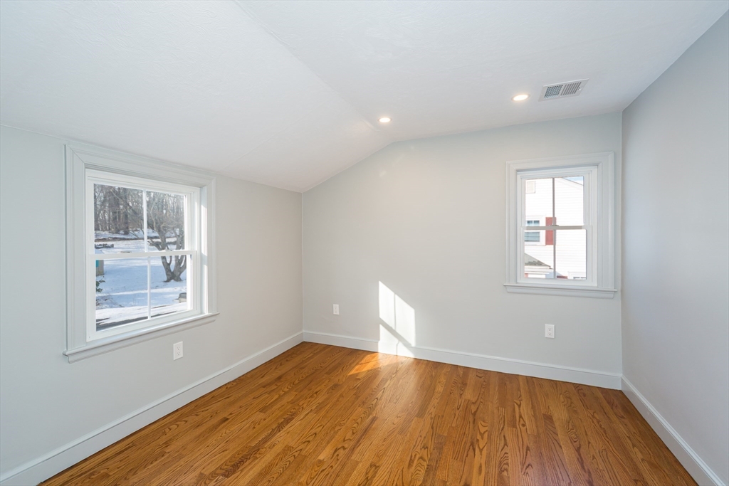 12 Bay State Road Natick, MA 01760 - Photo 25 of 35 a view of empty room with wooden floor and fan