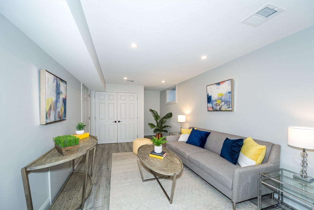 12 Bay State Road Natick, MA 01760 - Photo 28 of 35 a living room with furniture and a couch