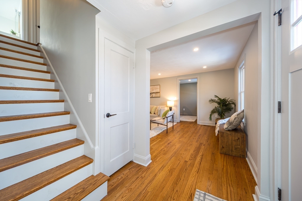 12 Bay State Road Natick, MA 01760 - Photo 6 of 35 a view of a livingroom with wooden floor and stairs