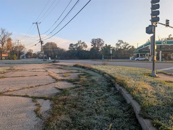 a view of a road with a building in the background