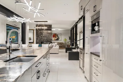 a large white kitchen with cabinets