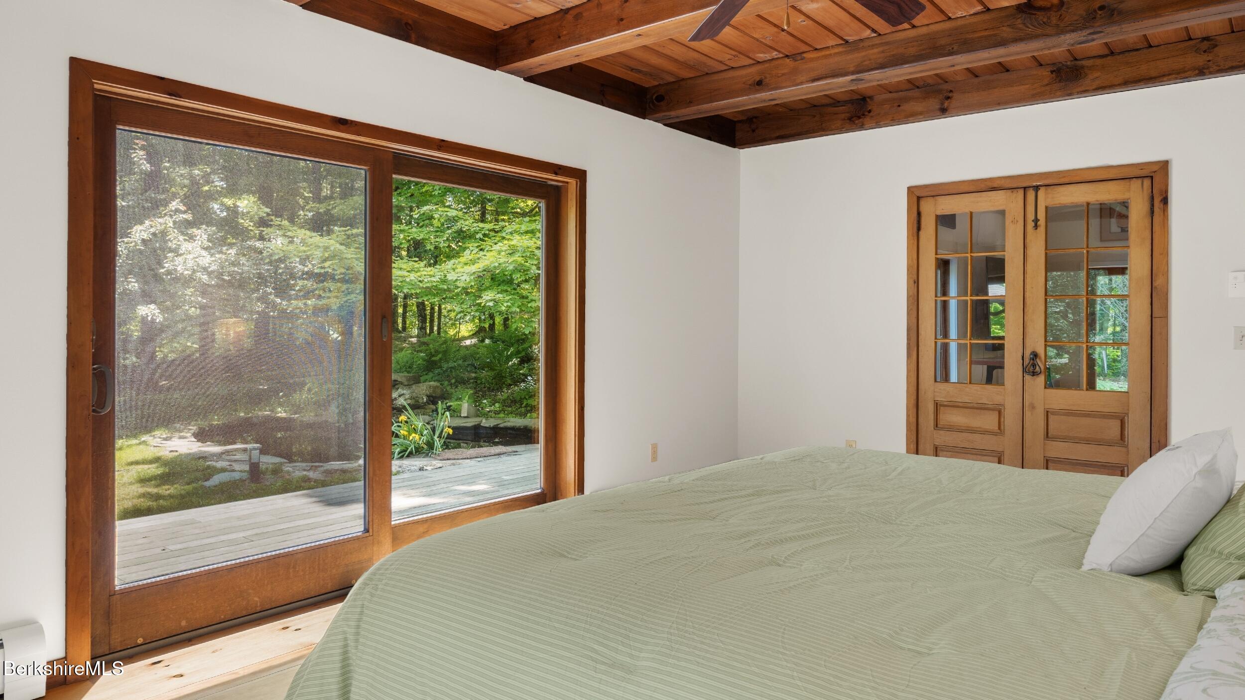 173 Hillsdale Road Egremont, MA 01230 - Photo 51 of 82 a bedroom with a bed and a large window with balcony view