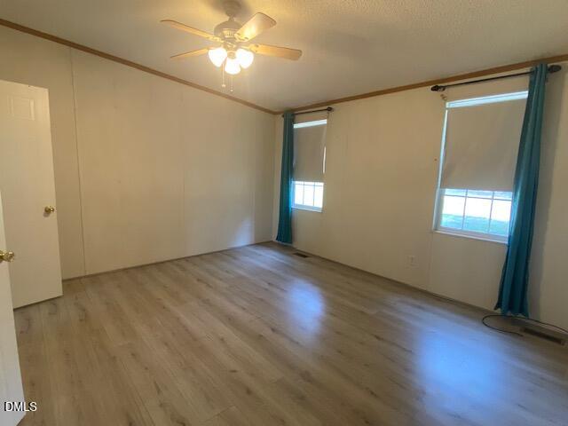 910 Vanco Mill Road Henderson, NC 27537 - Photo 11 of 17 an empty room with wooden floor and windows