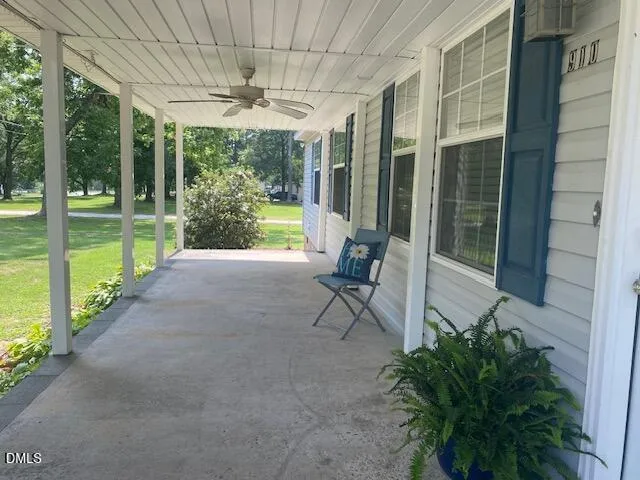 a view of a porch with chairs and backyard