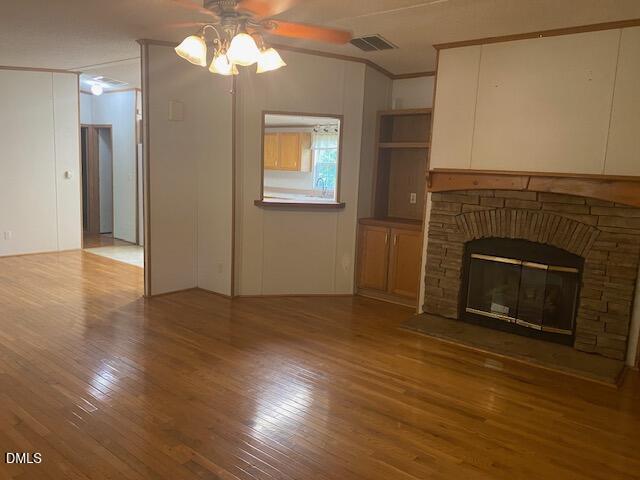 910 Vanco Mill Road Henderson, NC 27537 - Photo 7 of 17 a view of an empty room with wooden floor fireplace and a window
