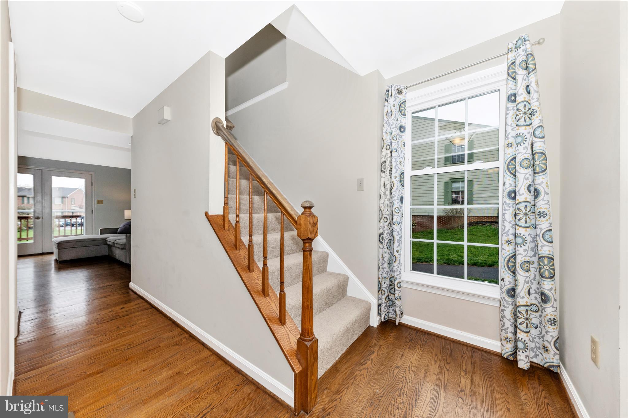 8226 Red Wing Court Frederick, MD 21701 - Photo 15 of 45 a view of front door with wooden floor and stairs