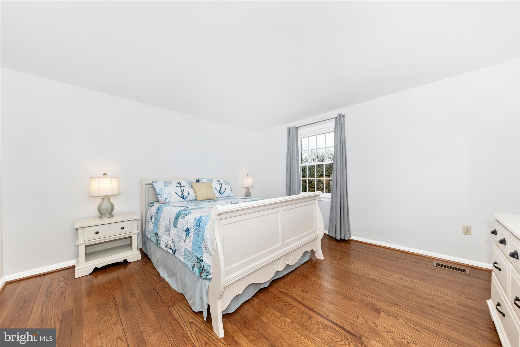 8226 Red Wing Court Frederick, MD 21701 - Photo 16 of 45 a view of a bedroom with bed and wooden floor