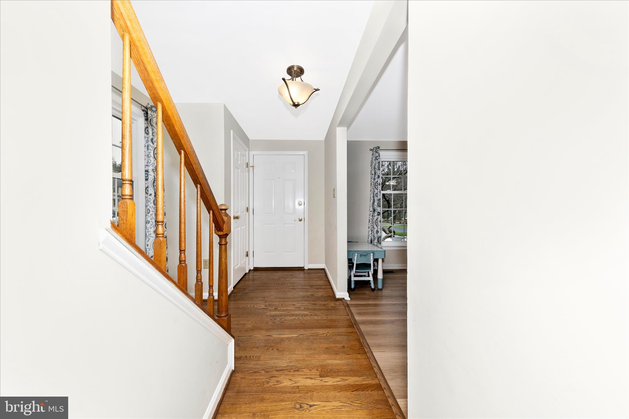 8226 Red Wing Court Frederick, MD 21701 - Photo 2 of 45 a way to bedroom with wooden floor and stairs