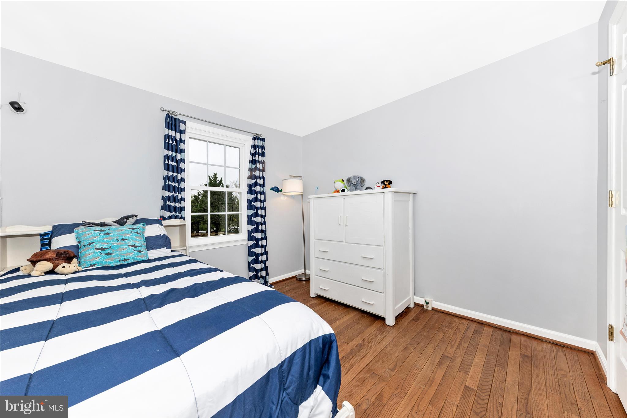 8226 Red Wing Court Frederick, MD 21701 - Photo 22 of 45 a bedroom with a bed and wooden floor