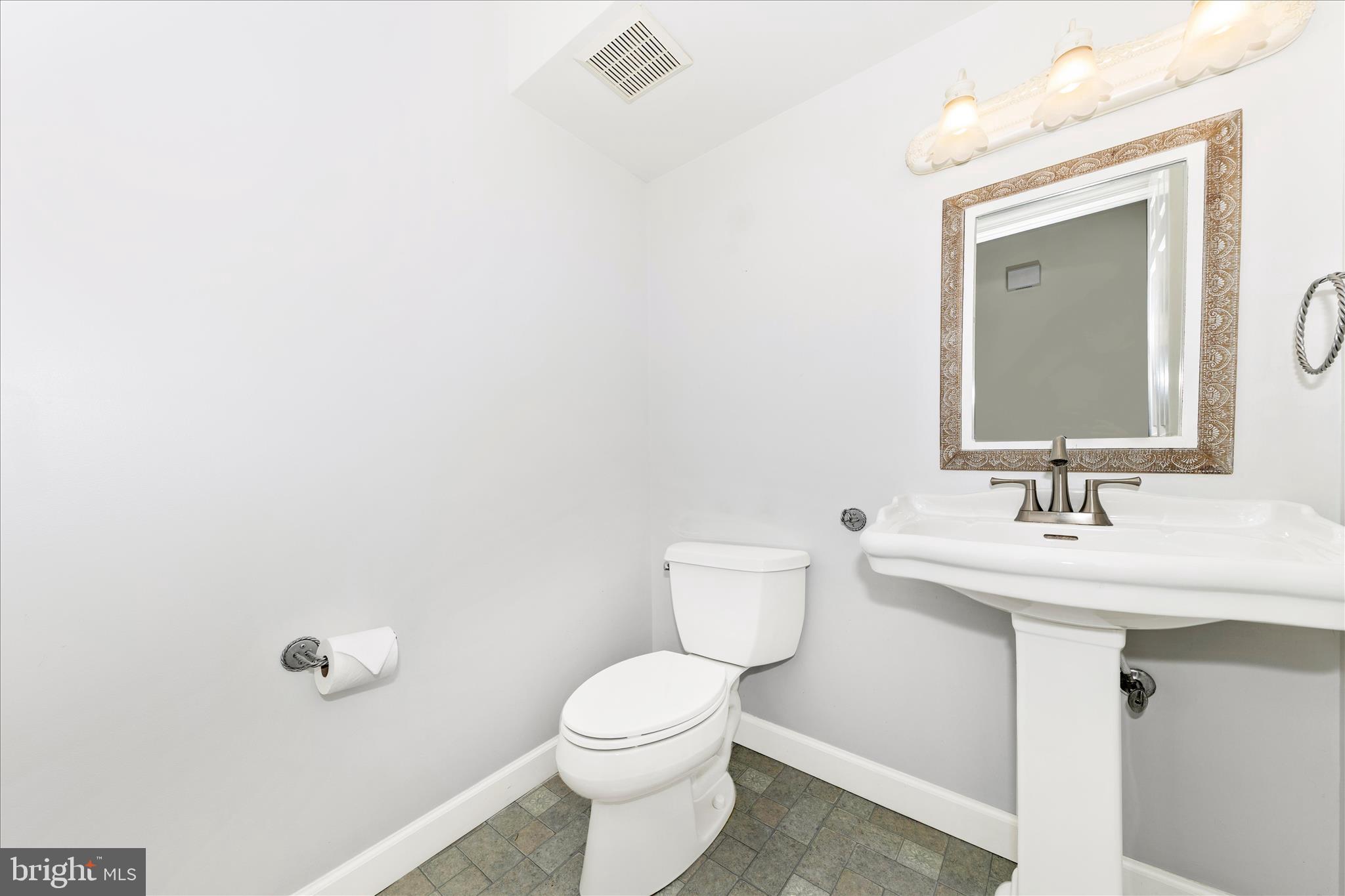 8226 Red Wing Court Frederick, MD 21701 - Photo 27 of 45 a bathroom with a toilet a sink and mirror