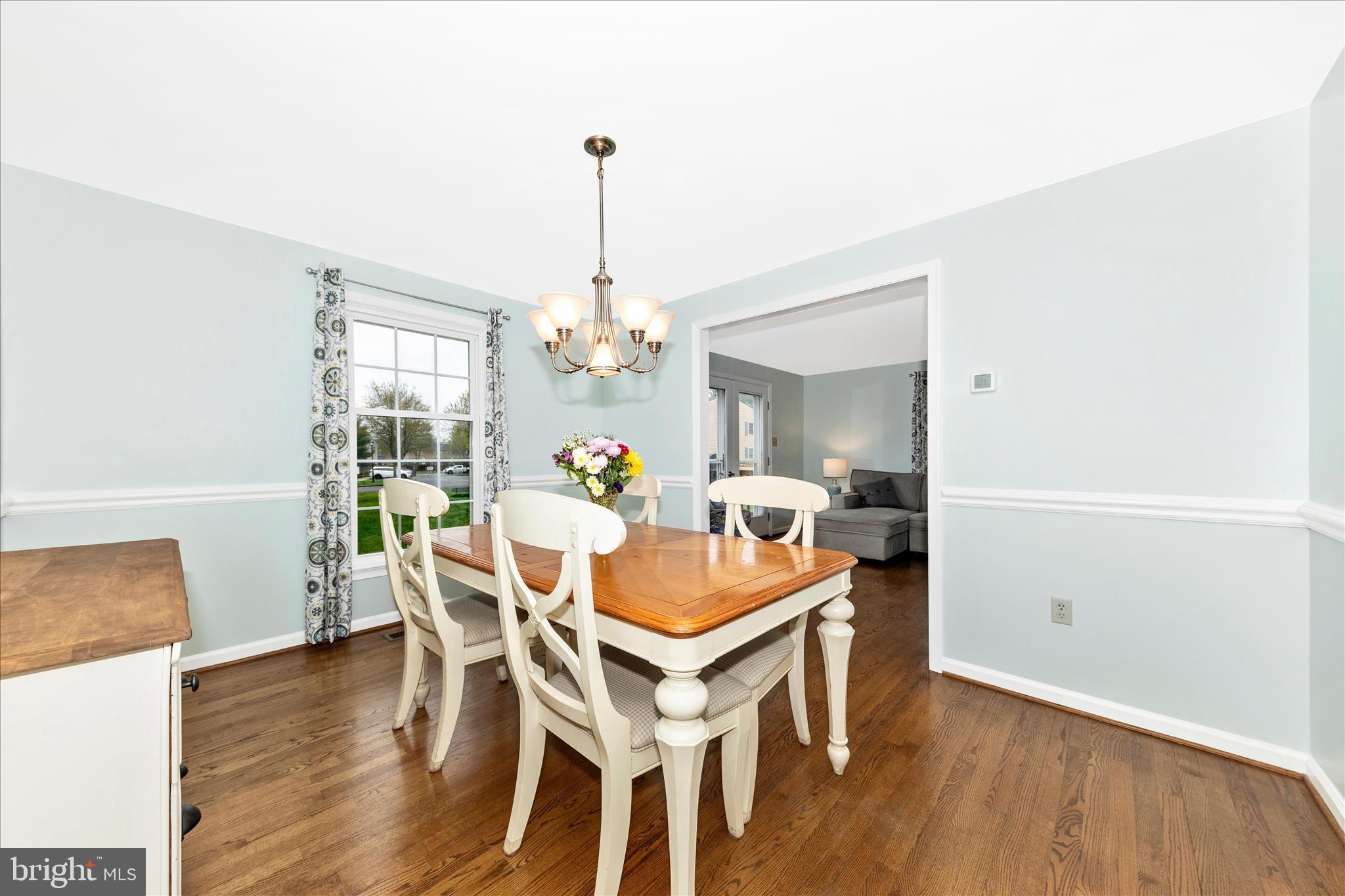 8226 Red Wing Court Frederick, MD 21701 - Photo 6 of 45 a dining room with furniture a chandelier and wooden floor