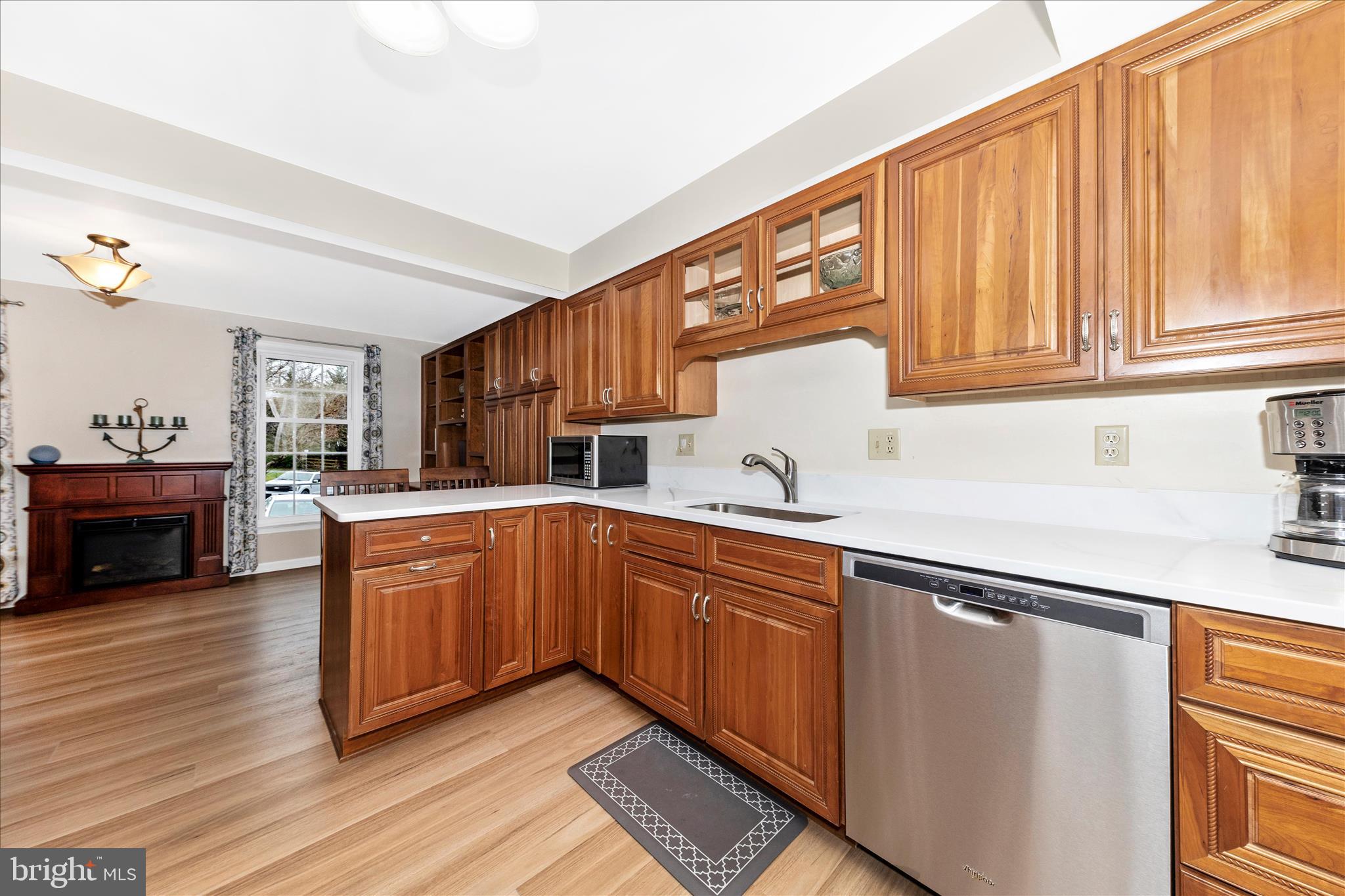 8226 Red Wing Court Frederick, MD 21701 - Photo 8 of 45 a kitchen with stainless steel appliances granite countertop a sink and cabinets with wooden floor