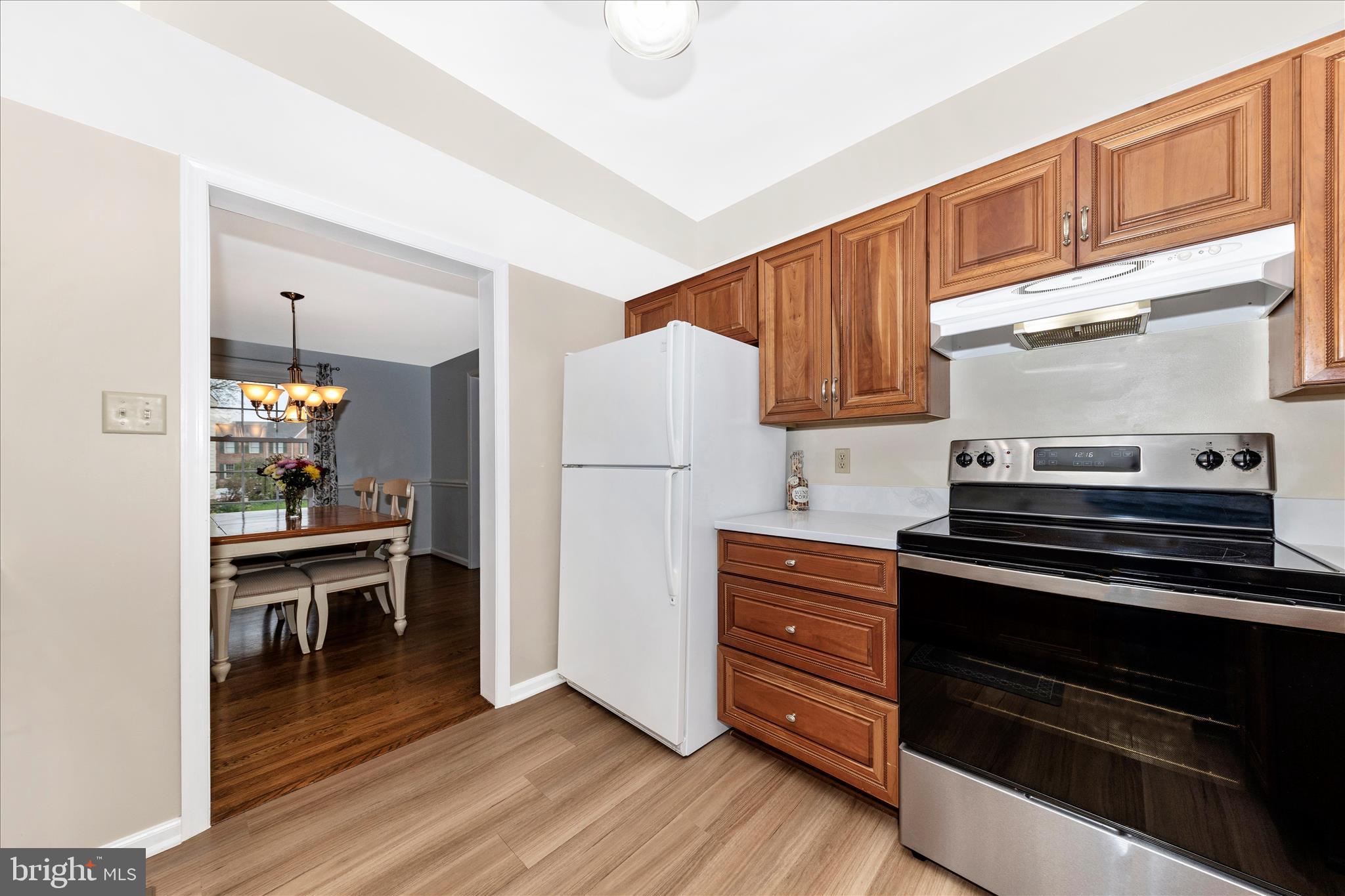 8226 Red Wing Court Frederick, MD 21701 - Photo 10 of 45 a kitchen with wooden cabinets and a stove top oven