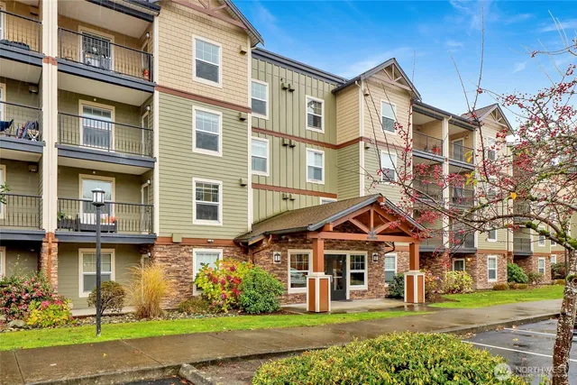 a front view of a residential apartment building with a yard