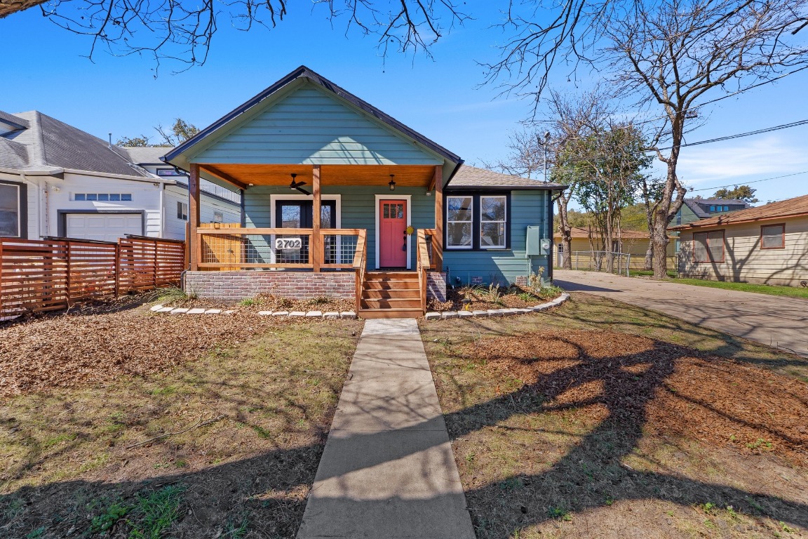 Bungalow-style home with fence and a porch