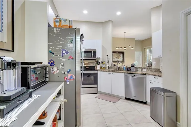 a kitchen with refrigerator and cabinets