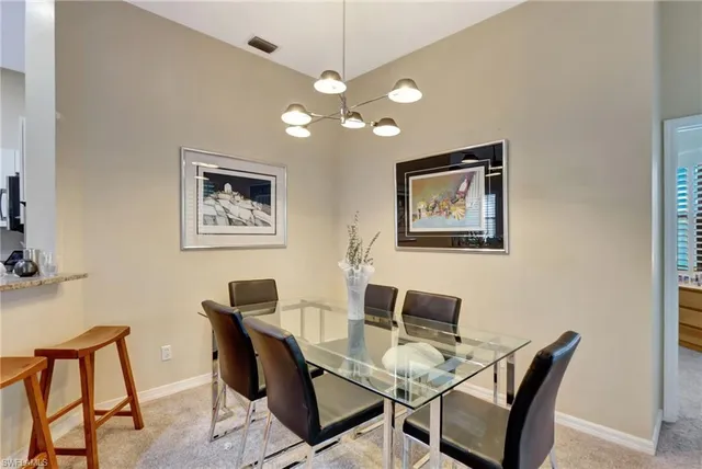a dining room with furniture and chandelier
