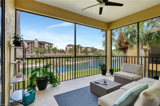 a living room with furniture and a floor to ceiling window