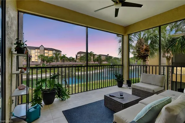 a balcony with couch and a potted plant