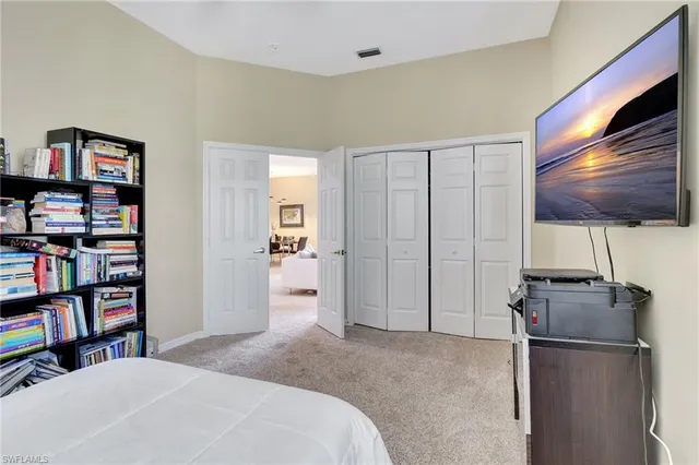 a bedroom with a bed and a television