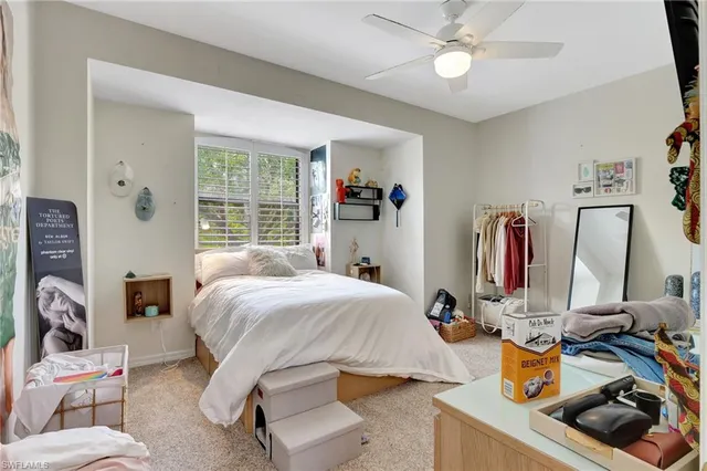 a bedroom with bed and a large mirror