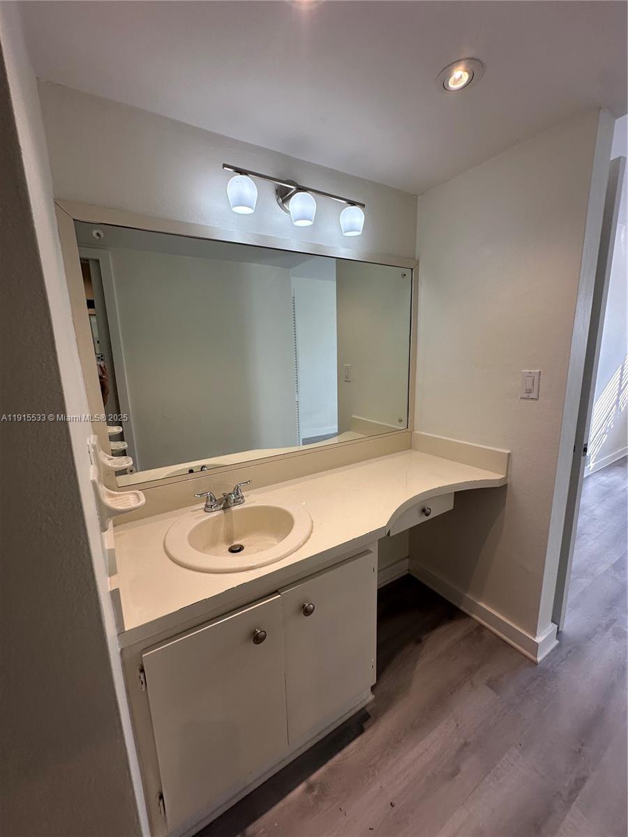 7505 Southwest 82nd Street, Unit 211 Miami, FL 33143 - Photo 13 of 17 a bathroom with a sink and a mirror