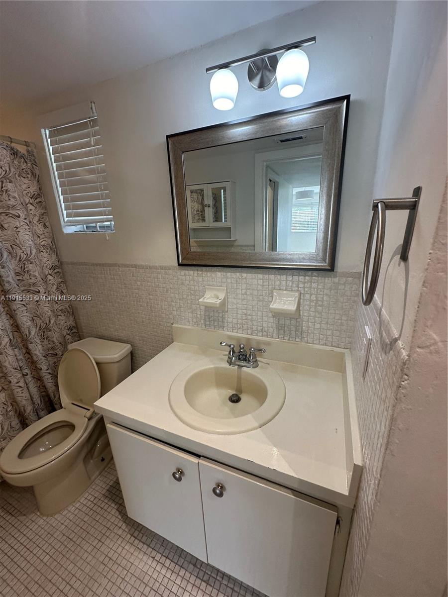 7505 Southwest 82nd Street, Unit 211 Miami, FL 33143 - Photo 10 of 17 a bathroom with a sink and a mirror