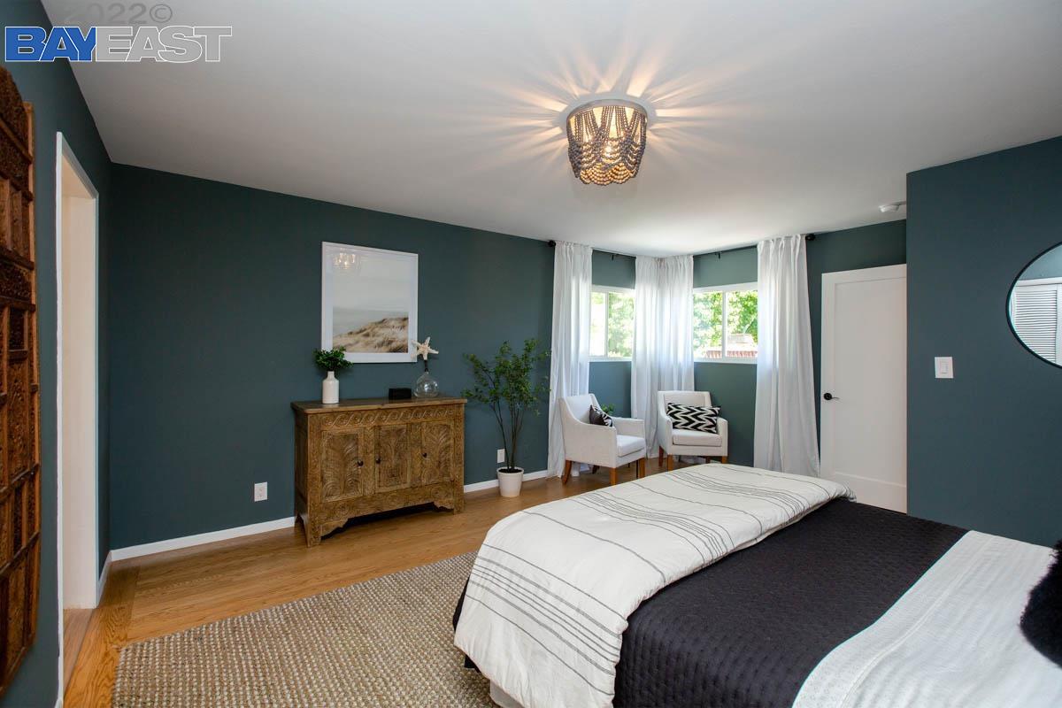 Gibbons Drive Alameda, CA 94501 - Photo 20 of 45 a bedroom with a bed and a chandelier