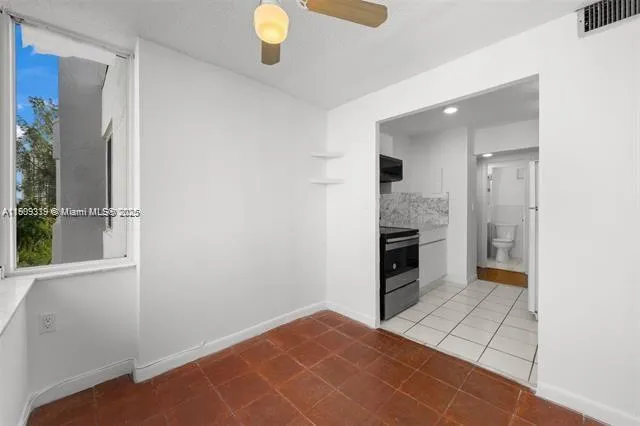 a view of a kitchen cabinets and a stove top oven