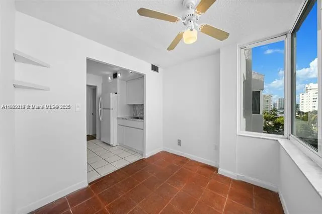 a view of a kitchen with a sink and a cabinet