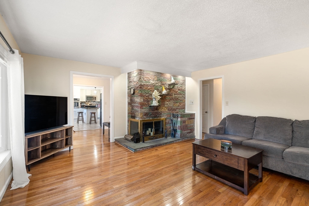 6 Wallace Road Sturbridge, MA 01566 - Photo 12 of 22 a living room with furniture flat screen tv and a fireplace