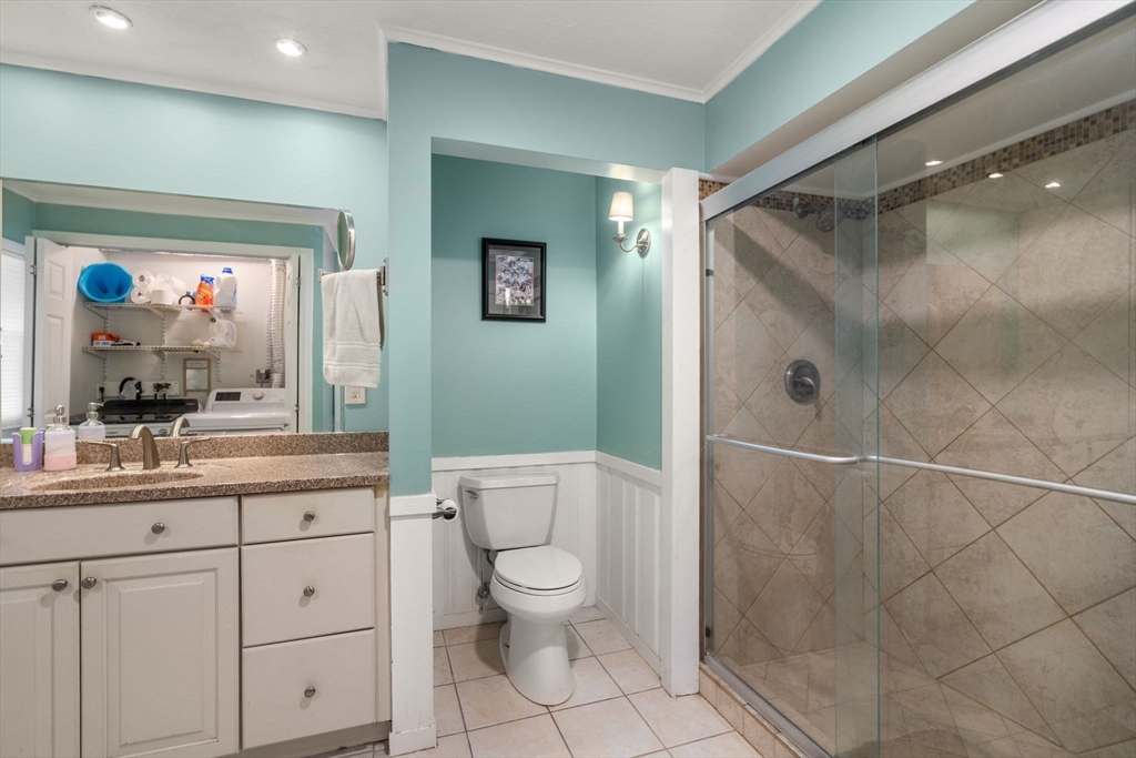 6 Wallace Road Sturbridge, MA 01566 - Photo 18 of 22 a bathroom with a toilet a sink and glass door shower
