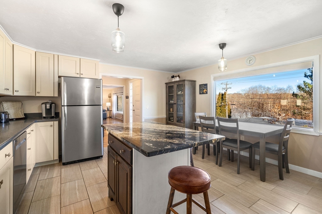 6 Wallace Road Sturbridge, MA 01566 - Photo 8 of 22 a kitchen with refrigerator and chairs
