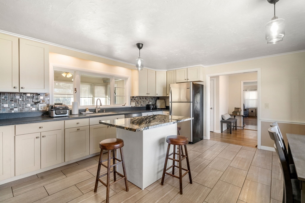6 Wallace Road Sturbridge, MA 01566 - Photo 10 of 22 a kitchen with a sink a refrigerator and chairs