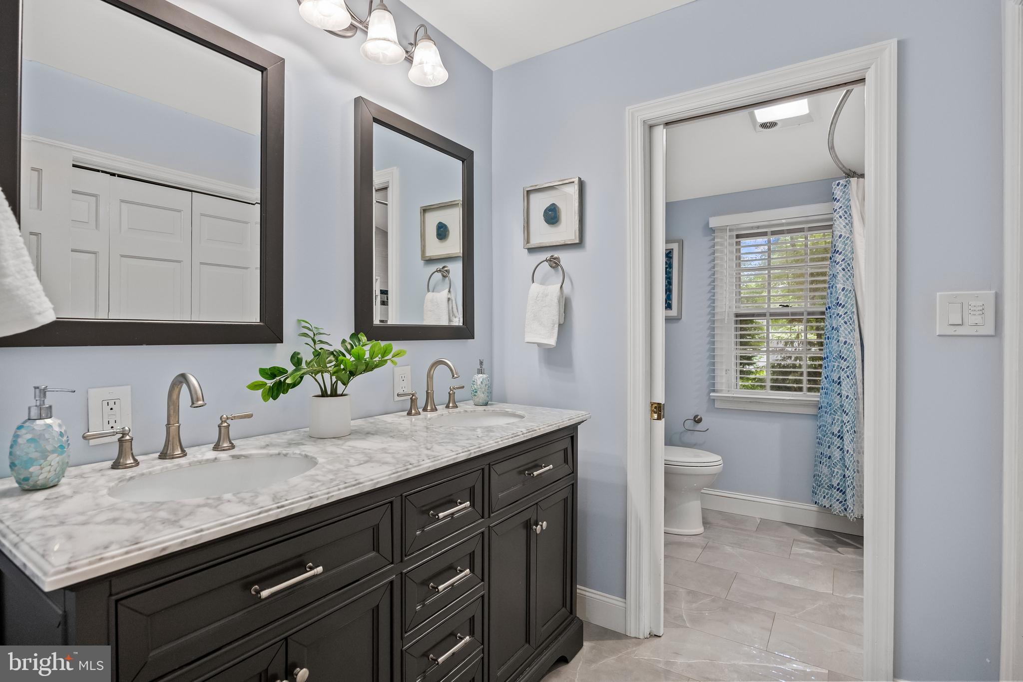 21 Robin Road Moorestown, NJ 08057 - Photo 50 of 82 a bathroom with a granite countertop sink a toilet and mirror