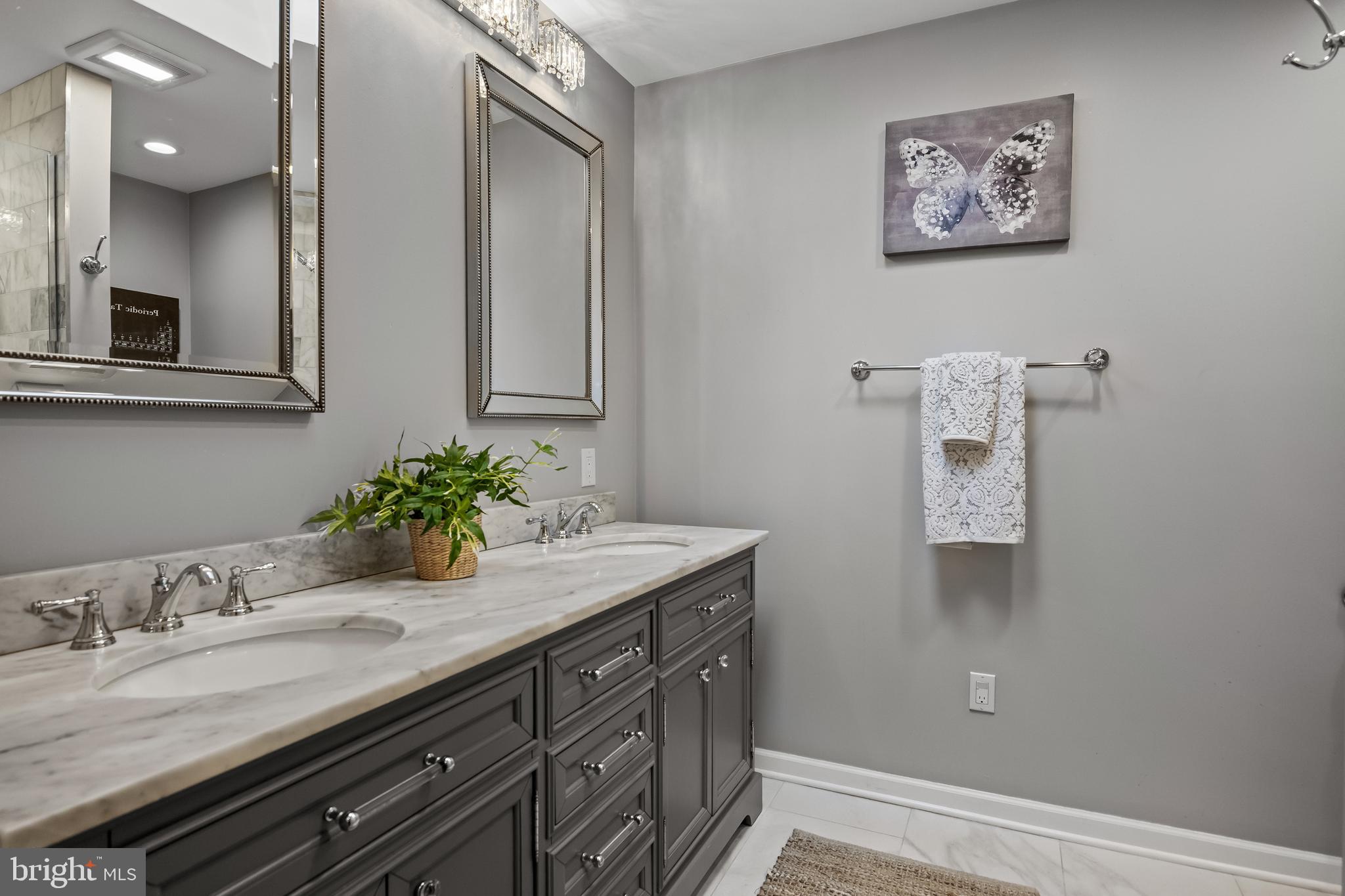 21 Robin Road Moorestown, NJ 08057 - Photo 52 of 82 a bathroom with a granite countertop sink a mirror and vanity