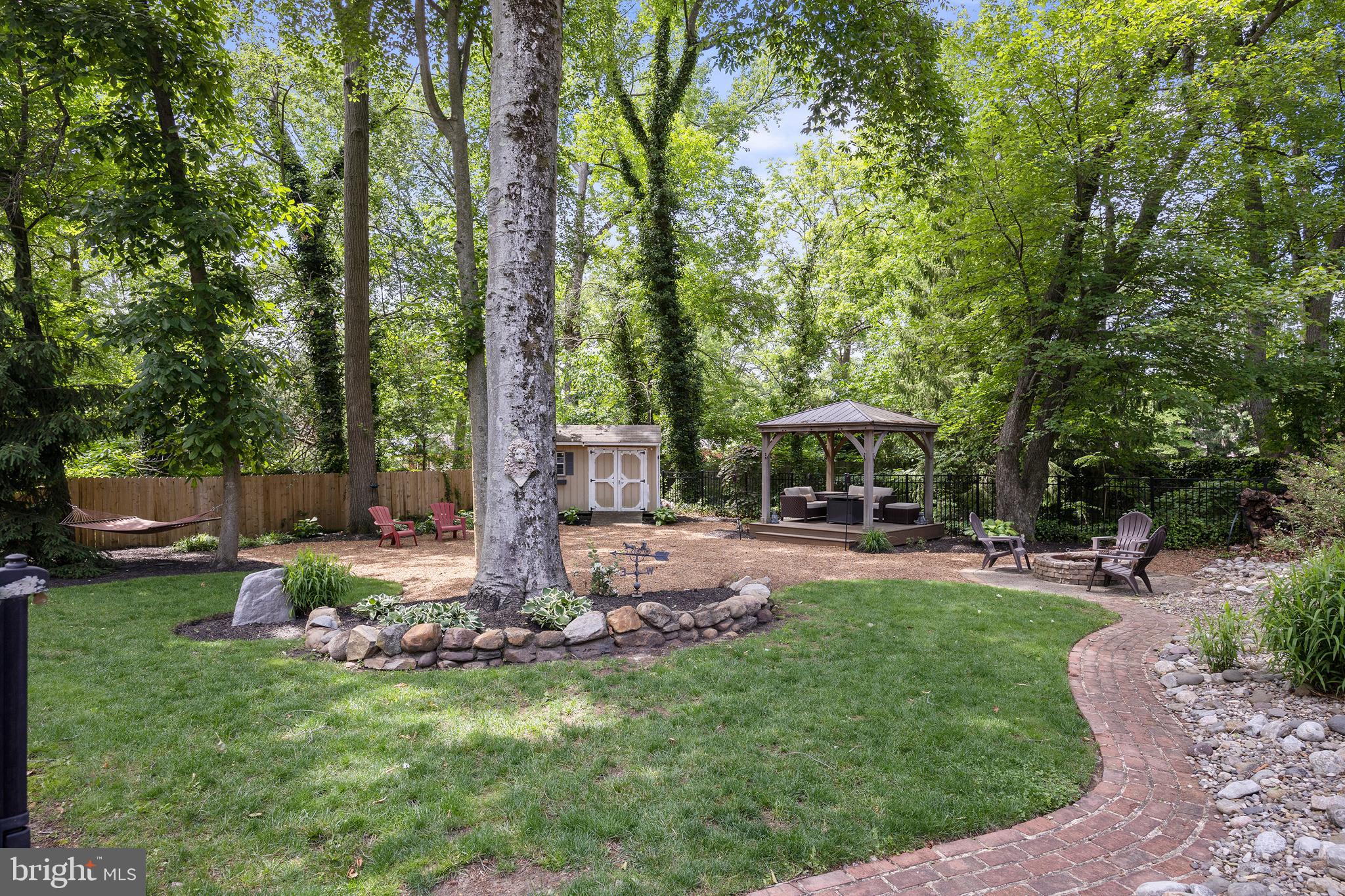 21 Robin Road Moorestown, NJ 08057 - Photo 69 of 82 a view of a backyard with table and chairs under an umbrella