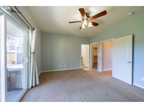 a view of a livingroom with a ceiling fan and window