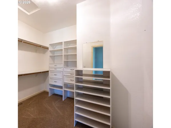 a view of walk in closet with empty racks