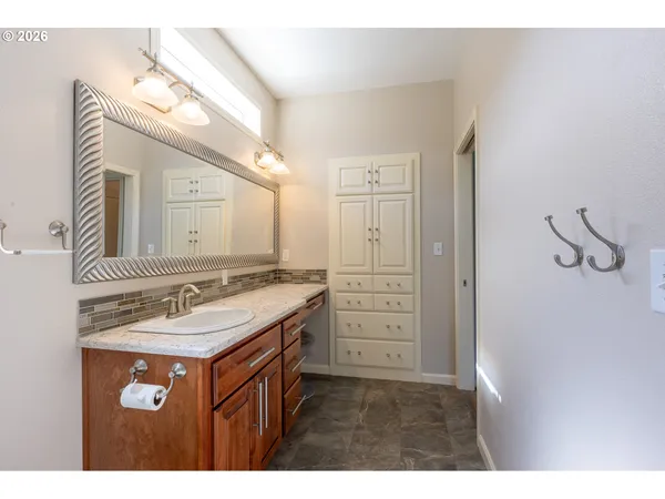 a bathroom with a sink vanity granite and a mirror