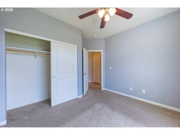 a view of an empty room with a ceiling fan