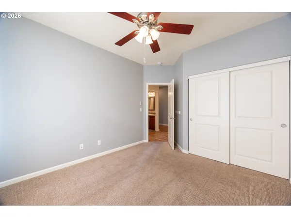 a view of an empty room with a ceiling fan