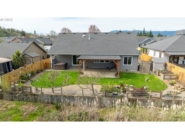 a aerial view of a house with garden space and a car parked