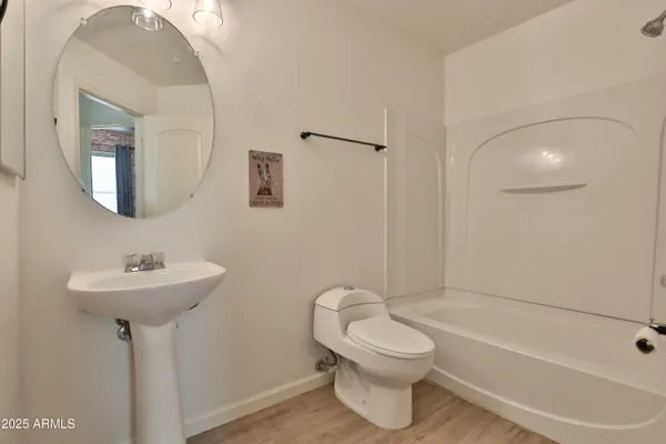 a bathroom with a toilet sink and shower