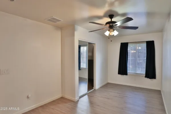 a view of an empty room with a fan