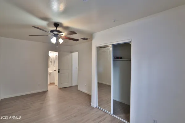 wooden floor in an empty room with a mirror
