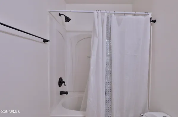 a bathroom with a shower and a tub