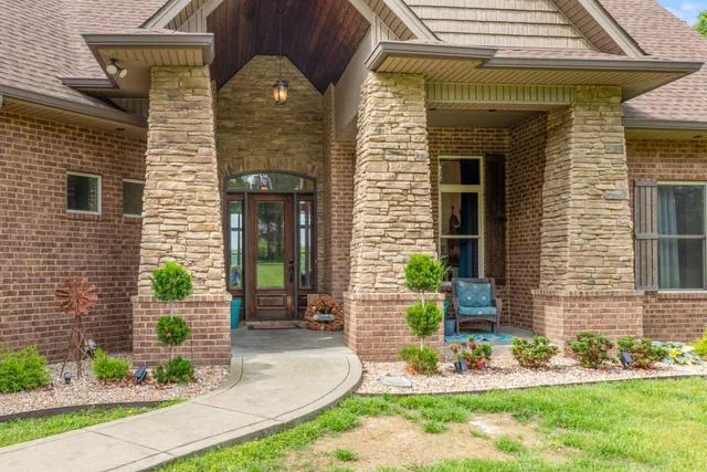 a front view of a house with garden