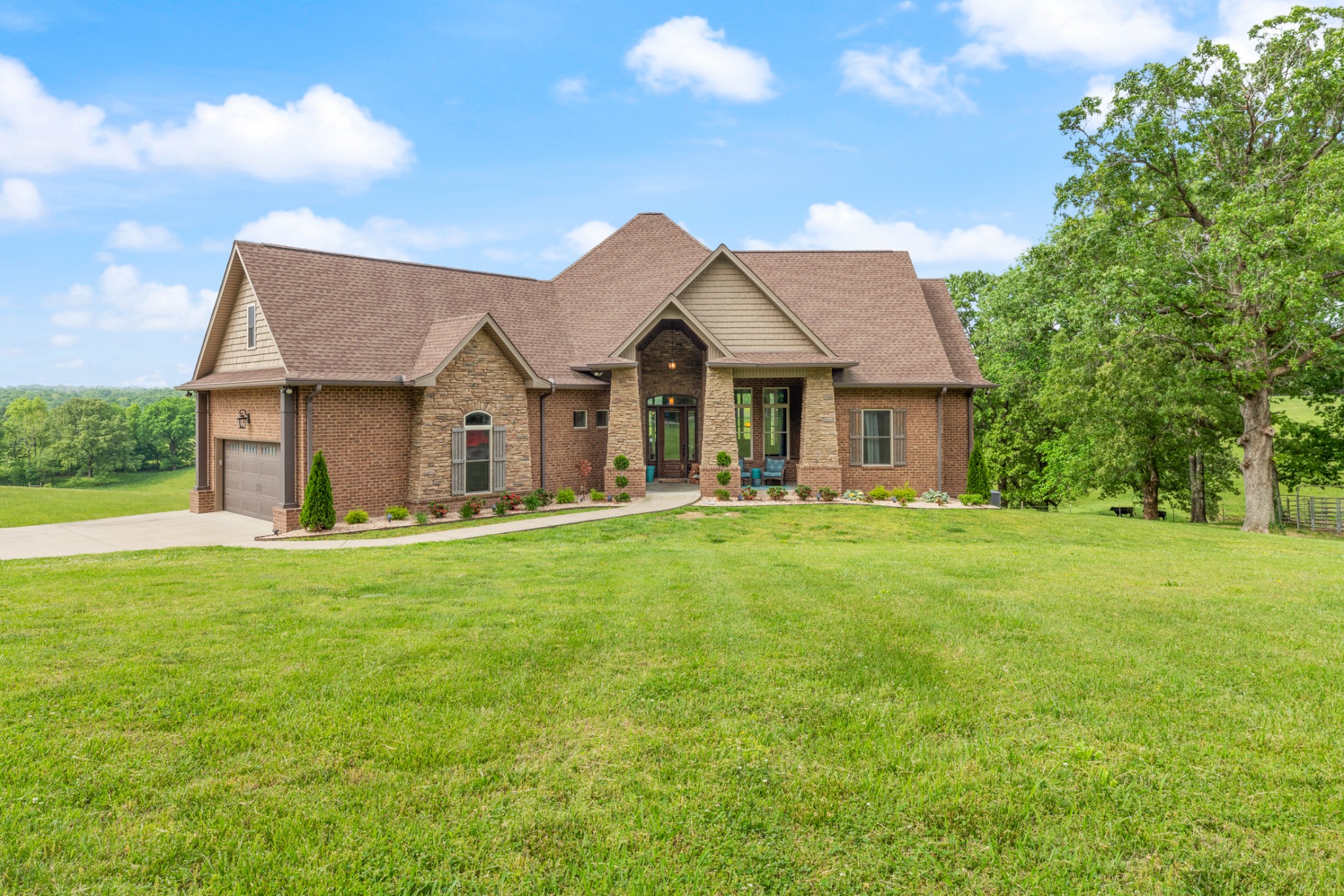 532 South Tidwell Road Bon Aqua, TN 37025 - Photo 2 of 100 a front view of a house with a garden and porch